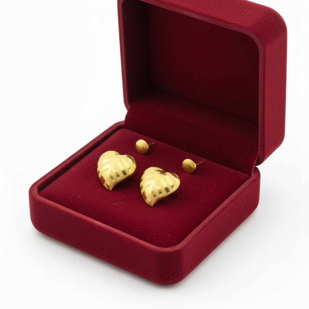 Heart-shaped gold earrings in a red velvet jewelry box, elegant and stylish design