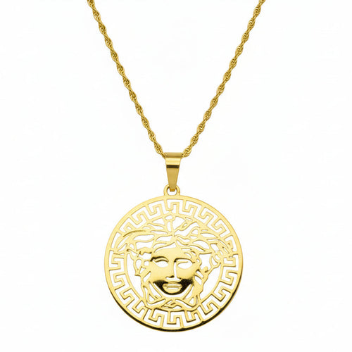 Gold necklace with a Medusa head pendant on a white background
