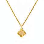 Gold necklace with a four-leaf clover pendant on a white background