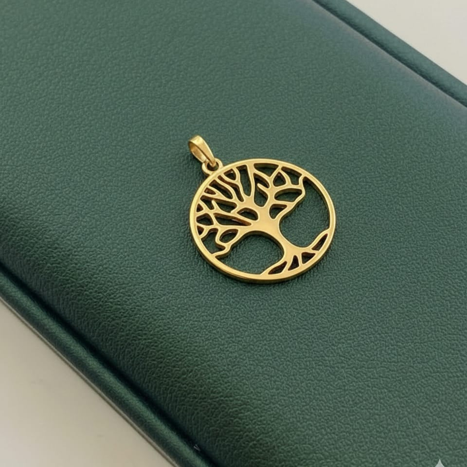 Gold tree-of-life pendant on a green leather surface