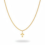 Gold necklace with cross pendant on a black velvet stand