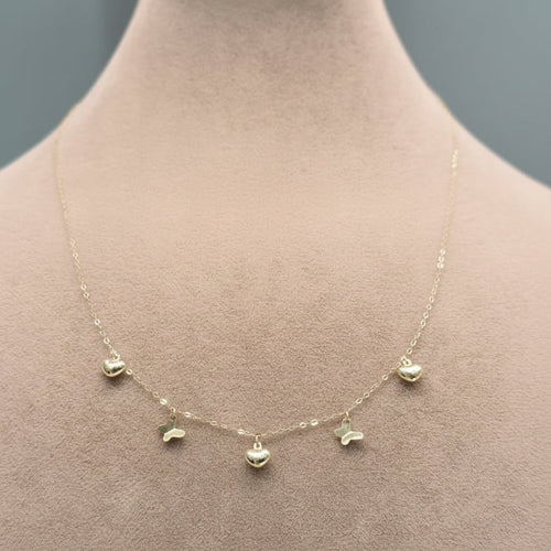 Gold necklace on a mannequin with weight and code displayed