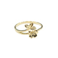 Gold ring with floral design on a gray background