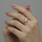 Gold ring with geometric design on a gray background